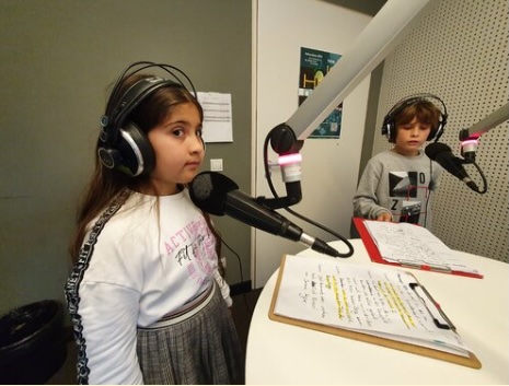 Junge Moderatorin am Mikrofon beim Telefoninterview mit Hanna Schilling